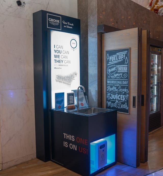 Branded hydration station at M1 Learning Media One Hotel for corporate event sustainability.