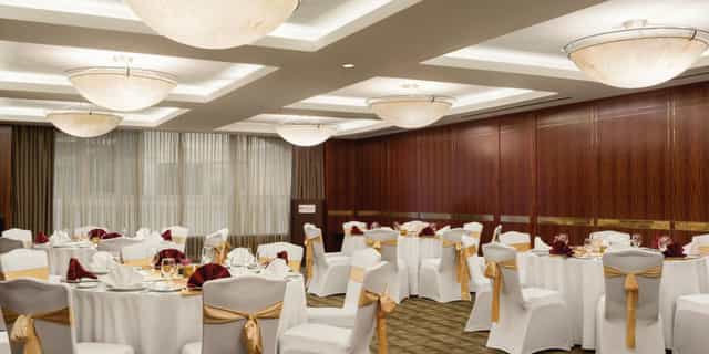 Large Meeting Room 2 with banquet settings and wood paneling for corporate events or formal galas.