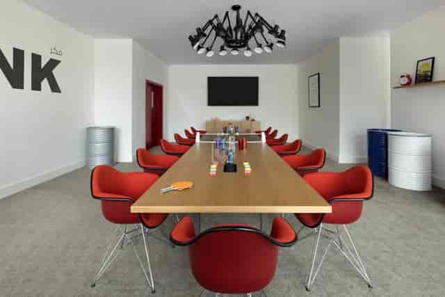 Co-working boardroom with ping-pong table for creative meetings and collaborative events.