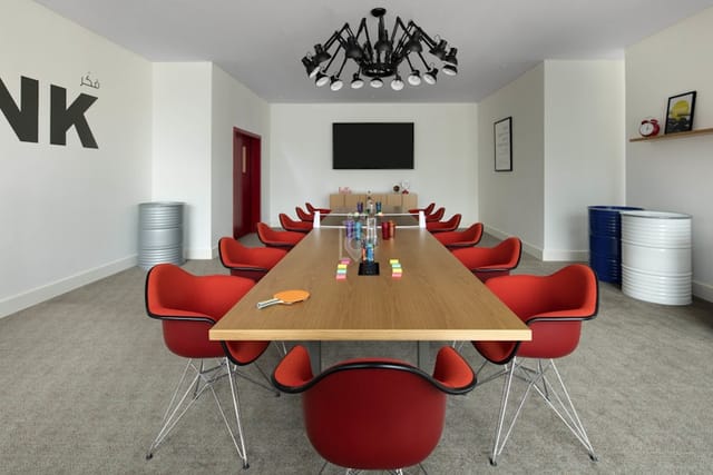 Co-working boardroom with ping-pong table for creative meetings and collaborative events.