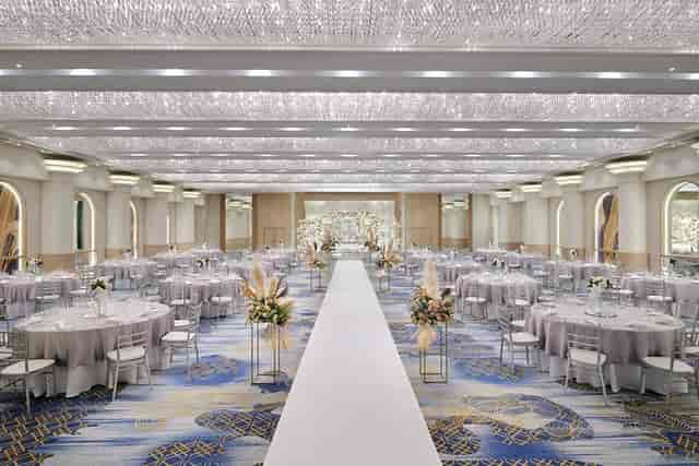 Luxury wedding ballroom in Dubai with floral pillars for elegant ceremony and reception events.