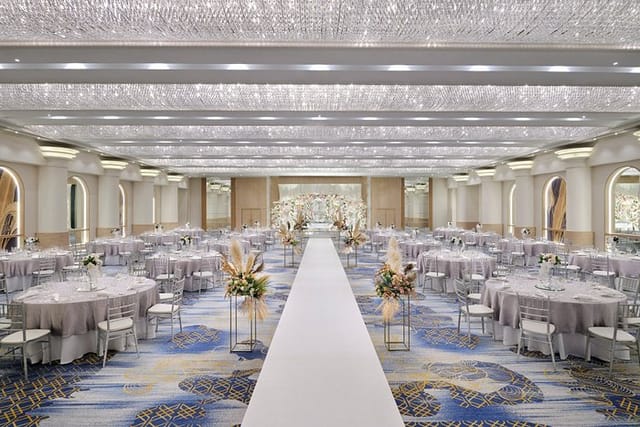 Luxury wedding ballroom in Dubai with floral pillars for elegant ceremony and reception events.
