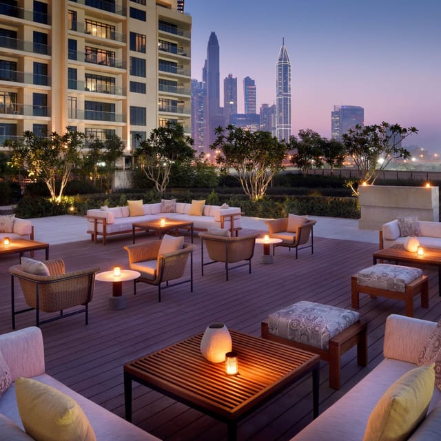 Outdoor corporate event terrace at Junipers, Vida Emirates Hills with city skyline views.