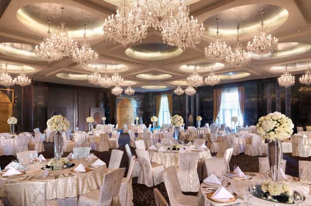 Luxury ballroom at Raffles Dubai with crystal chandeliers for weddings and gala events.