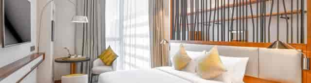 Modern luxury guest room at Huzza Grand Mercure Dubai City, ideal for VIP business travel events.
