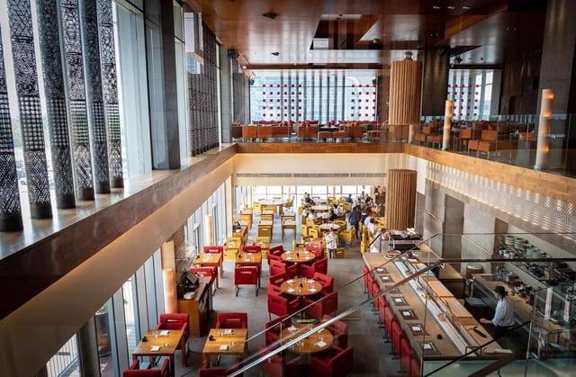 Zuma Dubai main dining area, high ceilings, corporate luncheon venue, networking reception.