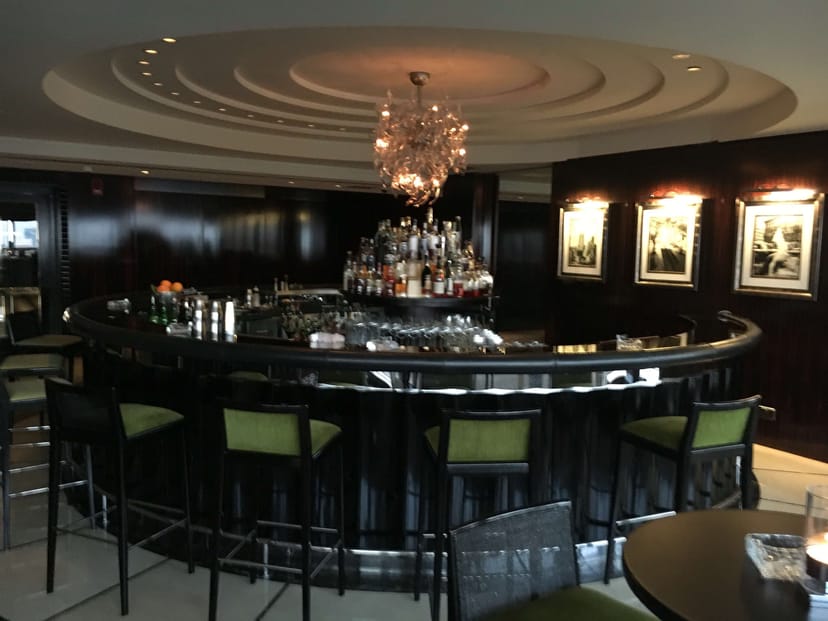 Sophisticated curved bar at Bar 44, ideal for executive networking events and corporate receptions.