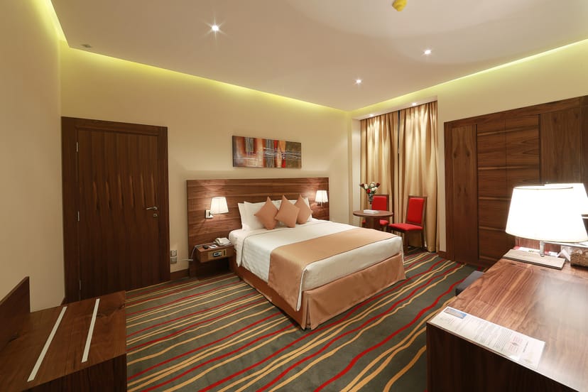 Al Khaleej Palace Deira Hotel suite with workspace for business travel and conference events.