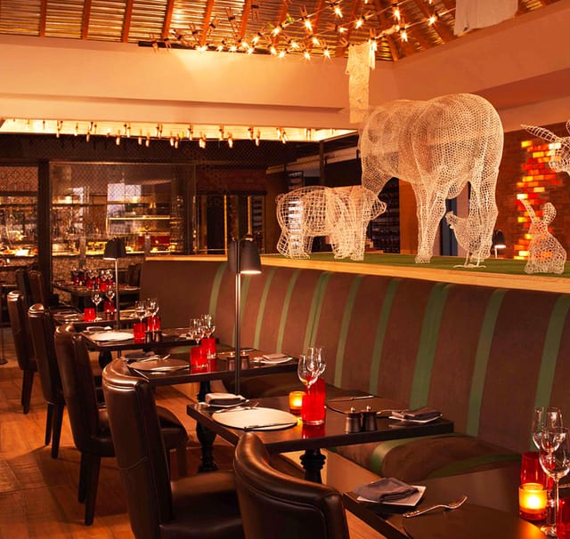 Bushman's Restaurant tiered seating with animal sculptures for upscale dinner and corporate events.
