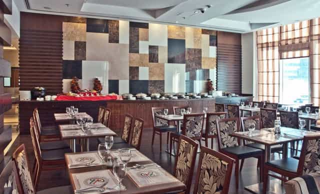 High-end hotel buffet restaurant, bright dining space for corporate events and networking dinners.