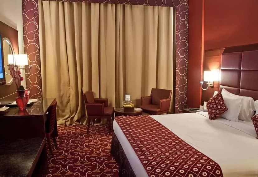 Standard hotel room with workspace at Ramee Rose Hotel for business travel and conference stays.