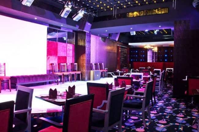 Ramee Rose Hotel event hall with stage and cabaret seating for corporate awards gala.