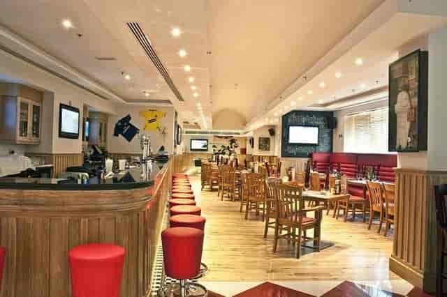 Ramee Rose Hotel sports bar: casual dining area for corporate networking and team happy hours.