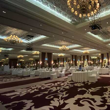Waldorf Astoria Dubai ballroom set for cabaret-style corporate workshop or luxury wedding event.