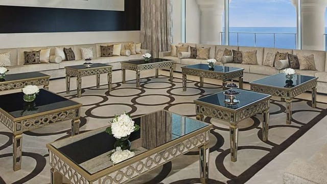 Upscale Waldorf Astoria Dubai reception lounge with ocean views for luxury corporate events.