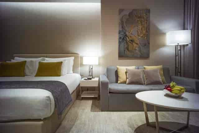 JA Lake View Hotel room with seating area, ideal for executive meetings and corporate consultations.