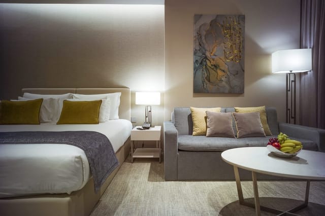 JA Lake View Hotel room with seating area, ideal for executive meetings and corporate consultations.