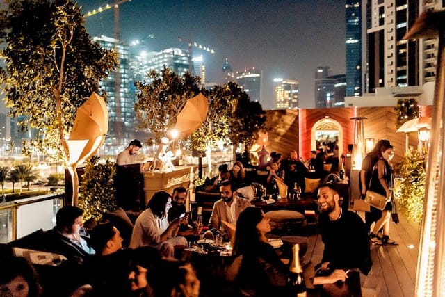 Rooftop bar at Treehouse with city skyline, premium evening networking event.