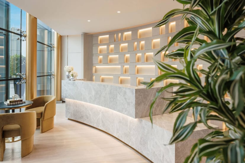 Modern hotel reception at Olivine Jumeirah for corporate event registration.