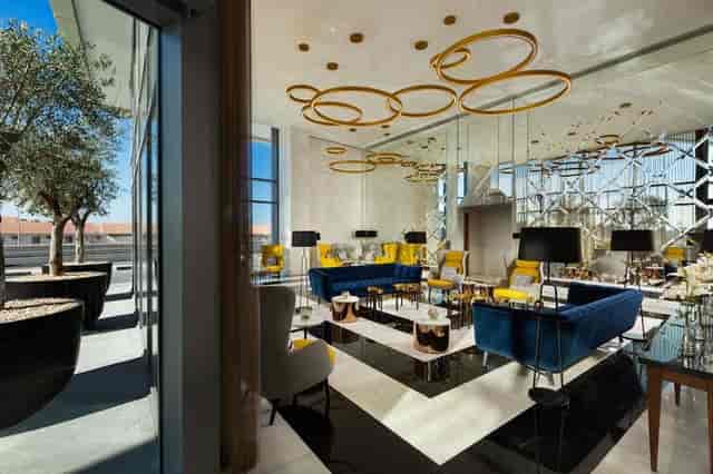 Contemporary pre-function lounge with jewel-toned seating for networking and executive events.