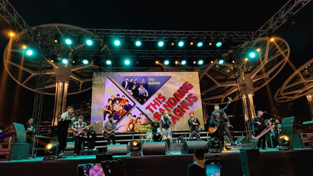 Band performing on LED-lit truss stage for live entertainment and concert event production.