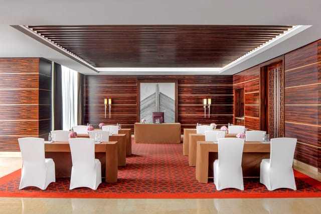Boardroom-style Lapis Meeting Room with wood paneling for executive meetings and training sessions.