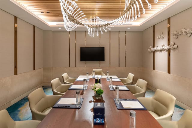 Luxury boardroom with statement chandelier for executive strategy sessions and corporate meetings.