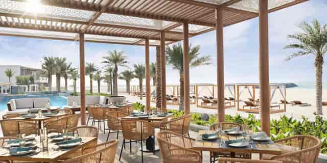 Upscale beachfront bar at InterContinental Ras Al Khaimah for corporate events and networking.
