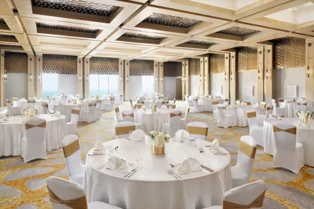 Lateen ballroom with gold decor: luxury corporate event and gala dinner venue in Ras Al Khaimah.