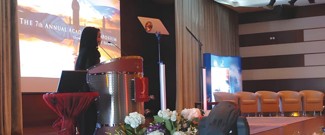 Zayed University Convention Center conference stage setup with professional AV and lectern.