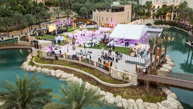 Corporate event at Fort Island, Madinat Jumeirah featuring a luxury marquee and stage setup.