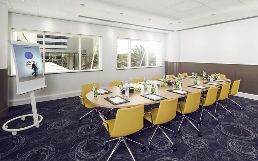 Boardroom-style corporate meeting room at Dubai World Trade Center with ergonomic seating.