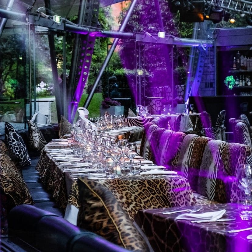 Animal-print restaurant interior with purple lighting for immersive event dining.