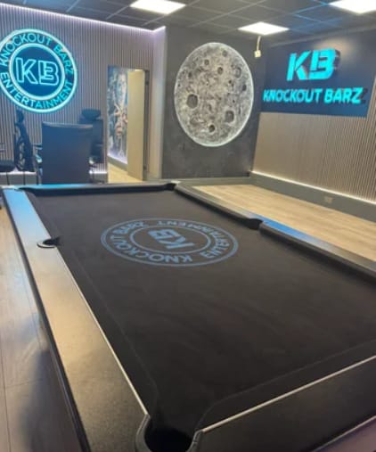 Branded pool table in Knockout Barz studio, perfect for corporate team building and networking.