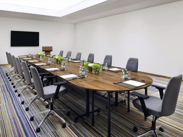 Boardroom with wooden table for executive meetings and corporate events.