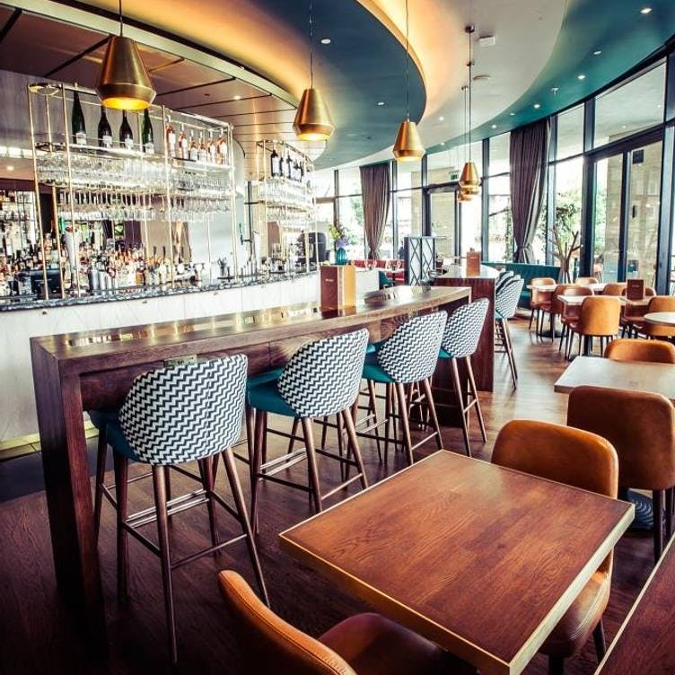Stylish bar area with modern seating, perfect for networking events and casual meetings.