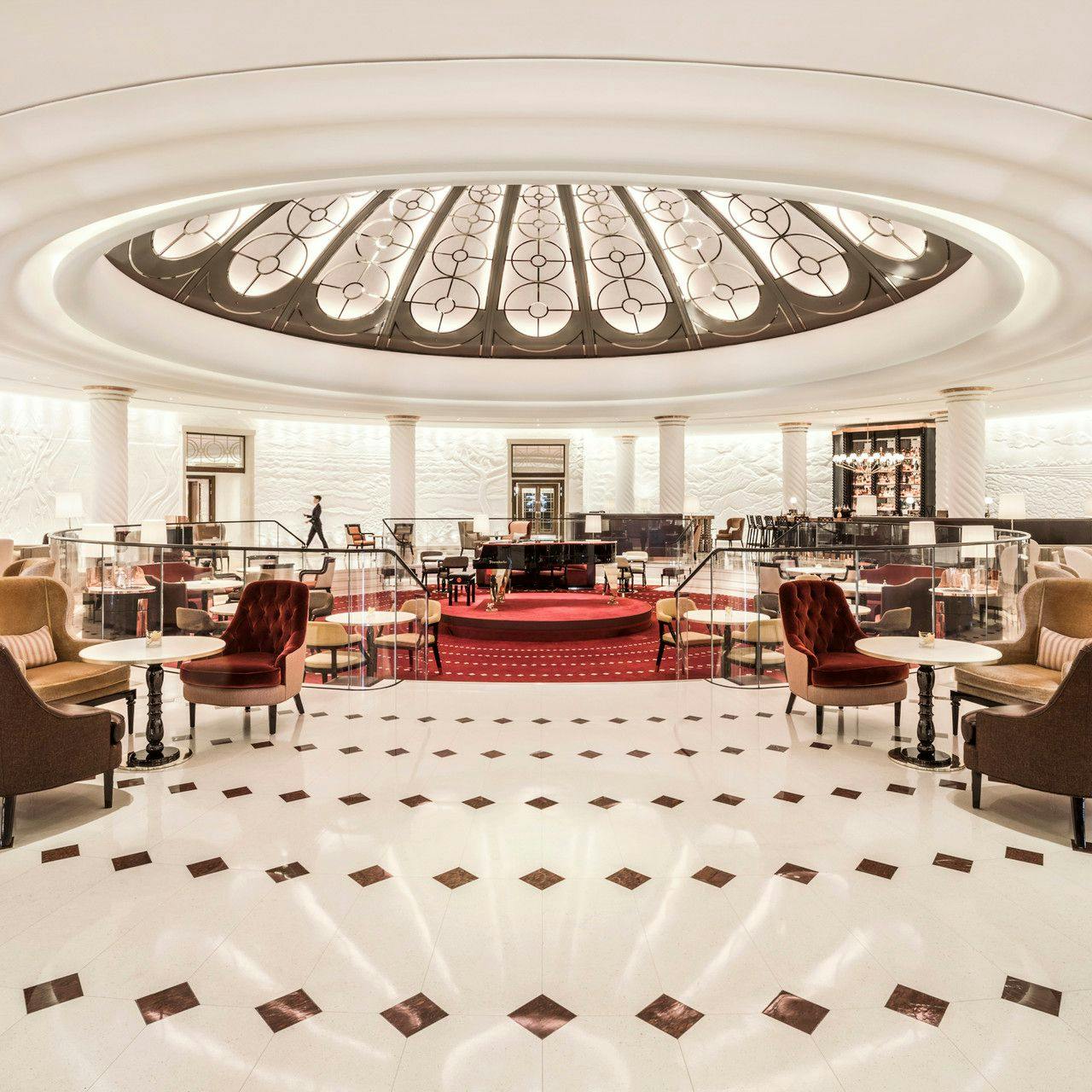 Elegant Rotunda Bar with grand piano, ideal for networking events and intimate gatherings.