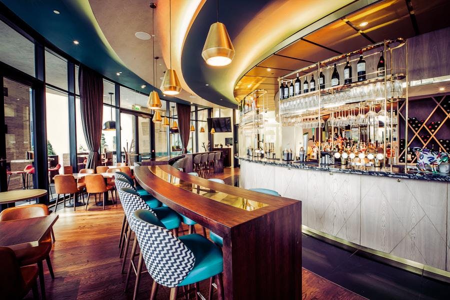 Stylish bar area with modern decor, perfect for networking events and cocktail receptions.