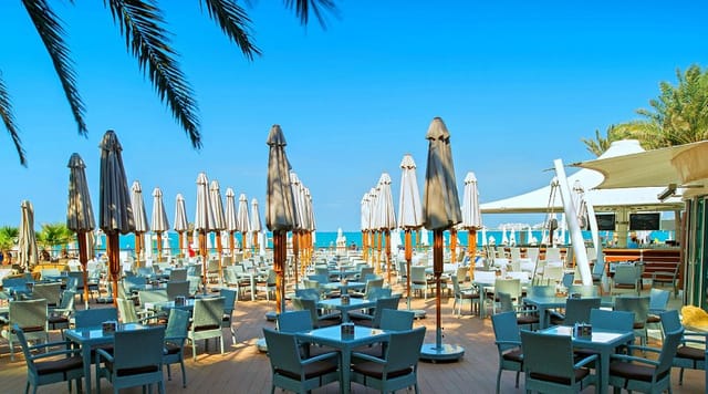 Wave Breaker, Address Beach Resort: vibrant outdoor event venue with ocean view and stylish umbrellas.