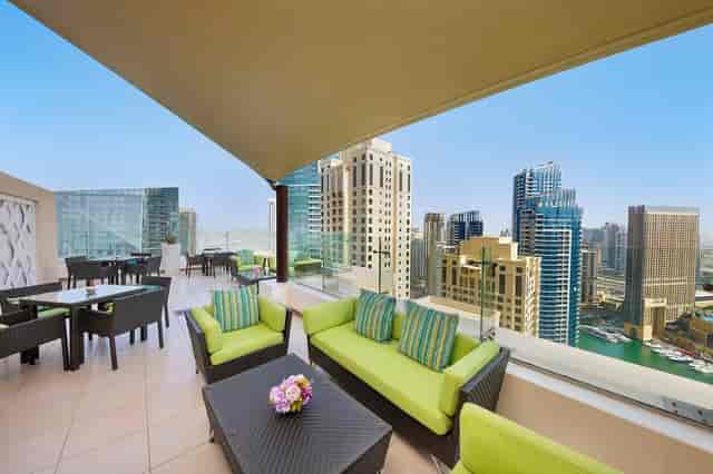 Executive Lounge rooftop at Hilton Dubai, featuring modern seating and stunning city views.
