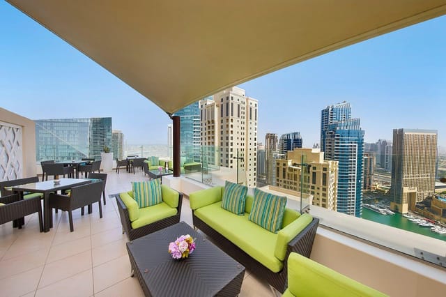 Executive Lounge rooftop at Hilton Dubai, featuring modern seating and stunning city views.
