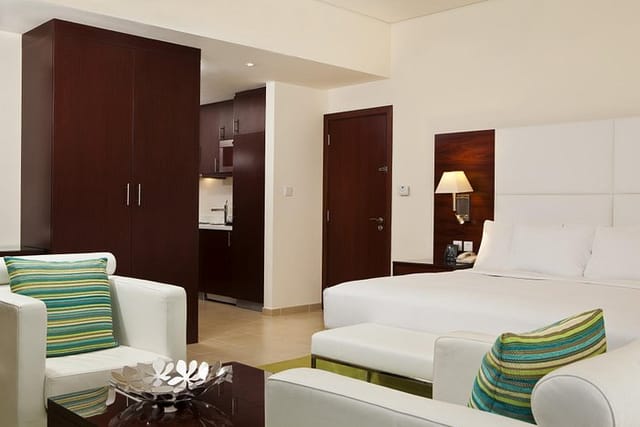 Modern hotel suite in Hilton Dubai, featuring kitchenette for comfortable event stays.