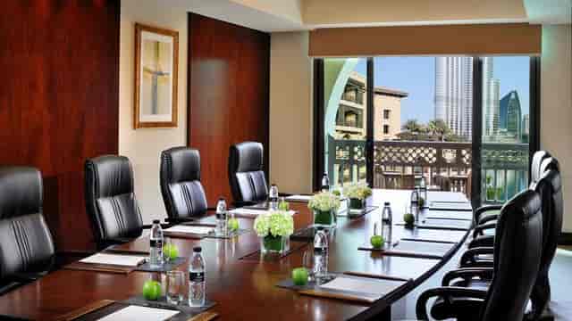 Elegant conference room with wood paneling, ideal for meetings and presentations.