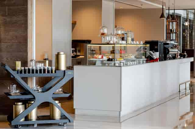 Modern café at The St. Regis Dubai, ideal for conference networking breaks and refreshments.