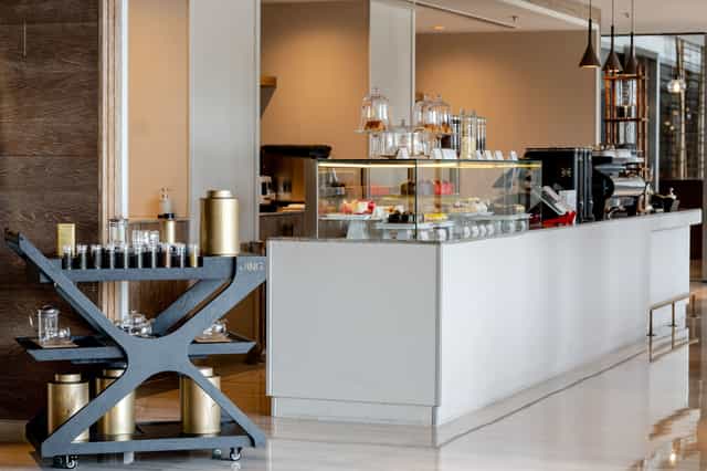 Modern café at The St. Regis Dubai, ideal for conference networking breaks and refreshments.