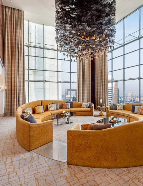 Royal Suite lounge in The H Dubai with plush seating and city views, perfect for events.