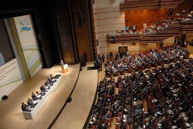 Plenary session in Megaron Athens auditorium, professional conference setup for business events.