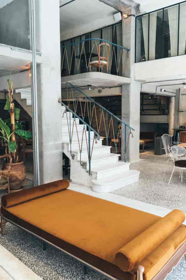 Industrial-chic lounge with architectural staircase for networking events and boutique activations.