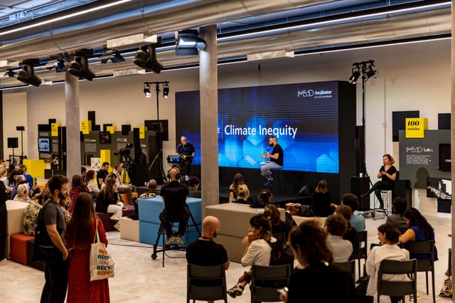 Corporate panel discussion at Arts Lounge Athens Conservatoire with LED backdrop and modern decor.