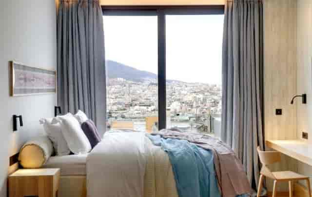 Modern Boulevard Room at COCO-MAT Athens with city view, ideal for business conferences and retreats.